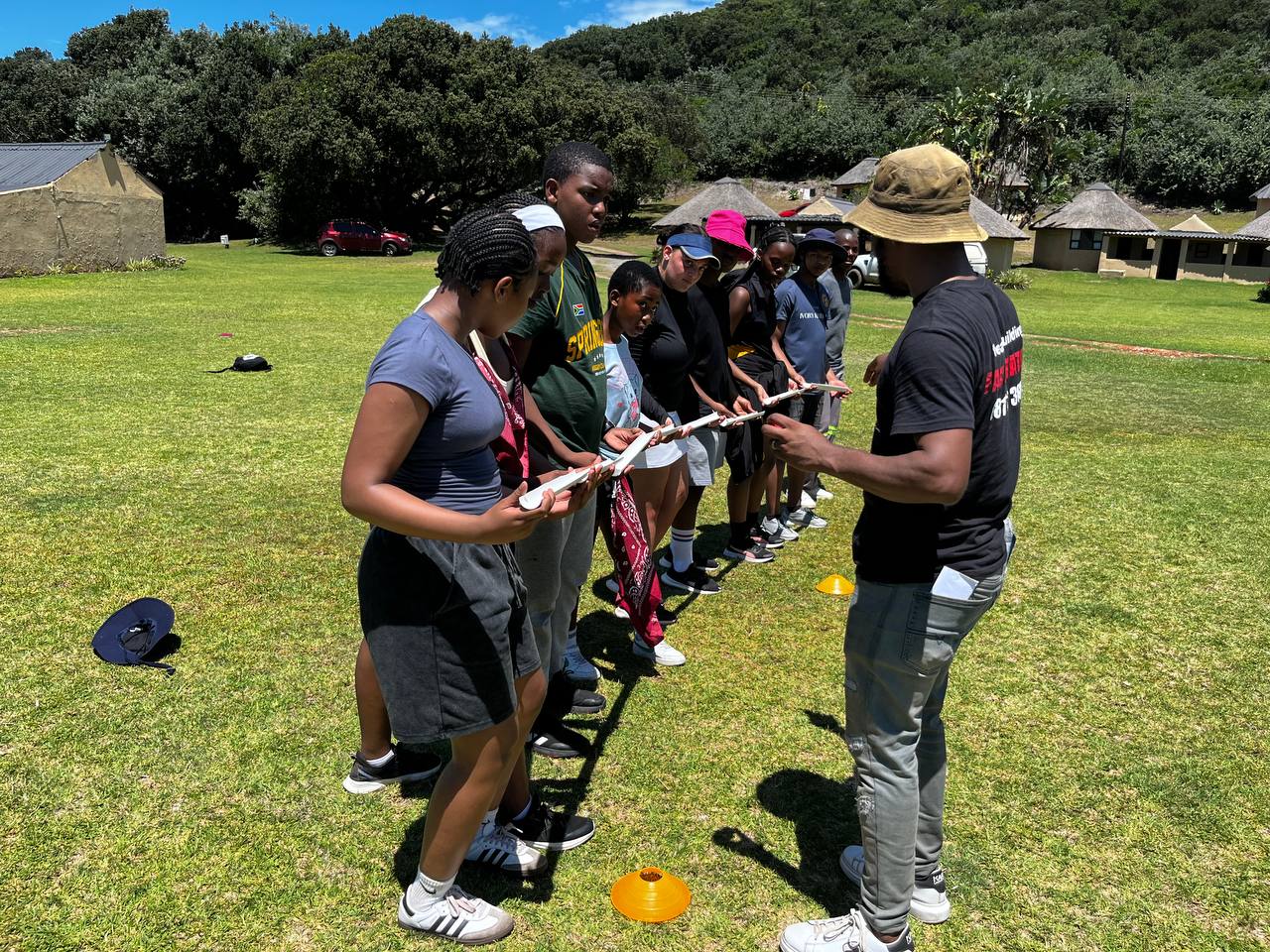 An MGA facilitator guiding participants through a line-based group challenge