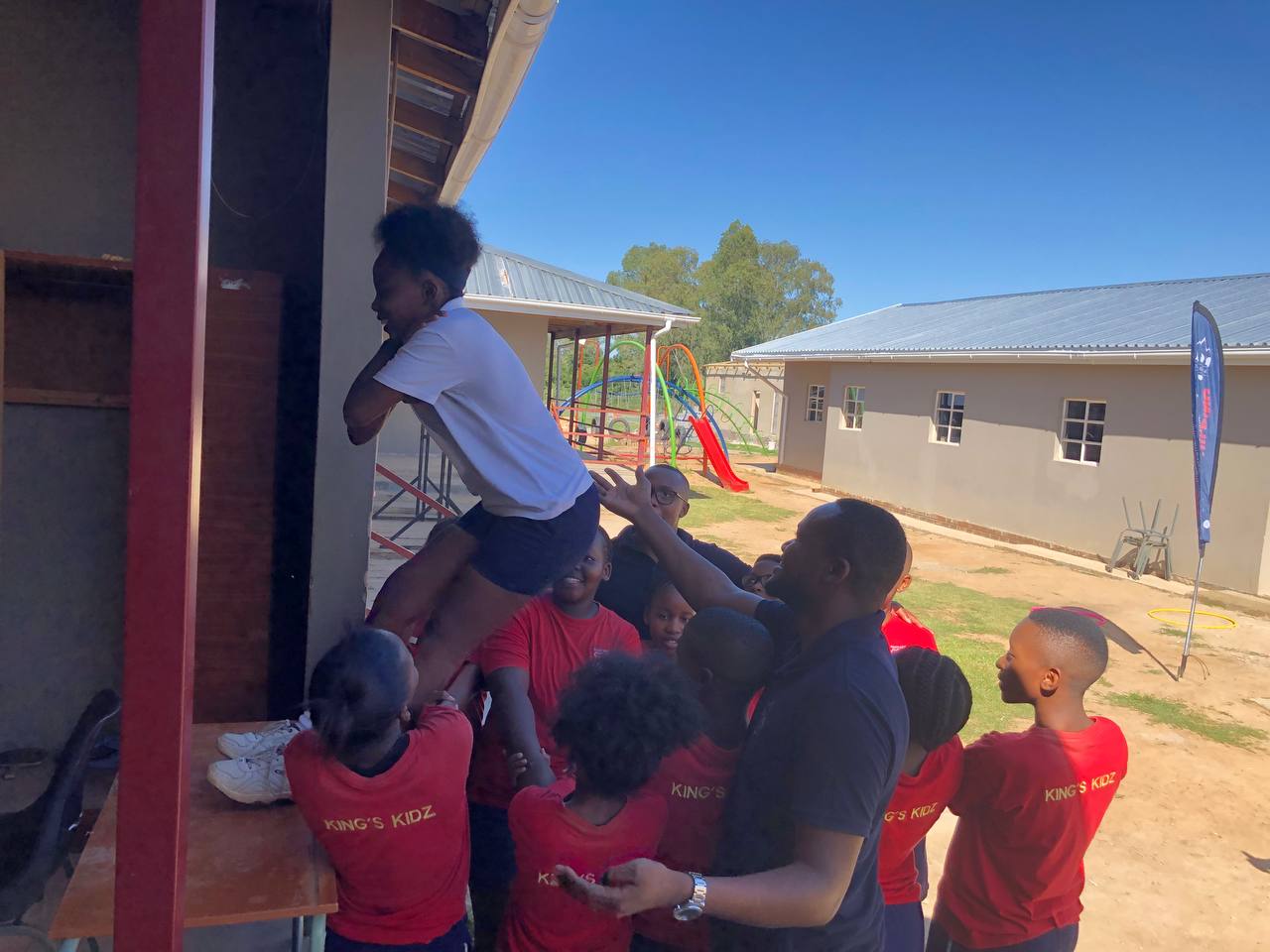 Learners supporting a teammate through a supervised school trust challenge